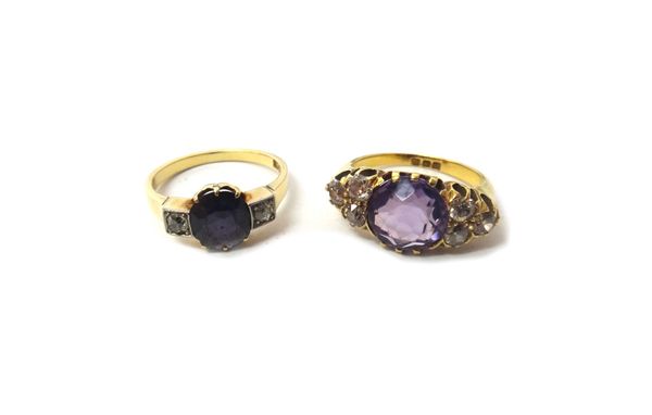 An 18ct gold ring, claw set with a cushion shaped amethyst at the centre, between diamond set three stone sides, London 1915, ring size J and a gold r