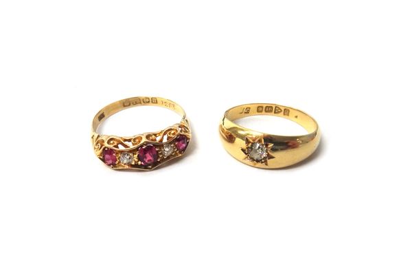 An 18ct gold ring, star gypsy set with a cushion shaped diamond, Chester 1916, ring size O and a half and an 18ct gold, ruby and diamond set five ston