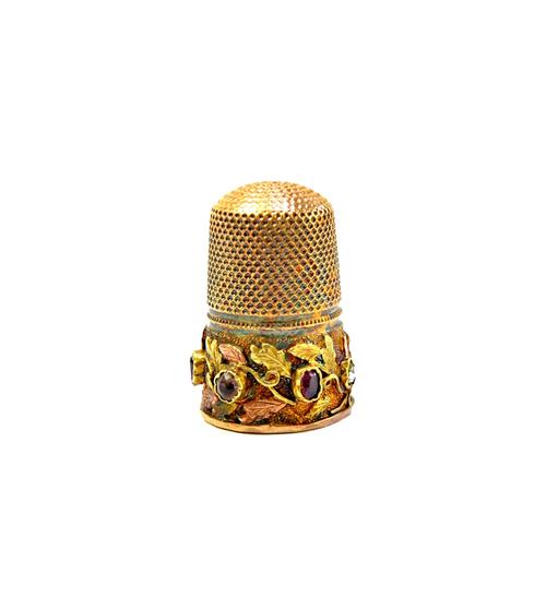 A Victorian two colour gold and gemstone set REGARD thimble, the gemstone set band with two colour gold, foliate decoration, mid 19th century.  Illust