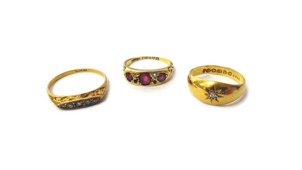 An 18ct gold ring, star gypsy set with a cushion shaped diamond, Chester 1908, an 18ct gold ring, mounted with three cushion shaped rubies and with tw