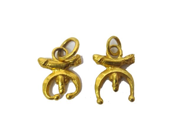 A pair of gold pendants, each in a phallic and curved design, combined weight 22.3 gms.