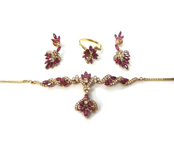 A gold, ruby and diamond set pendant necklace, in a scrolling and foliate design, mounted with marquise shaped rubies and with circular cut diamonds,