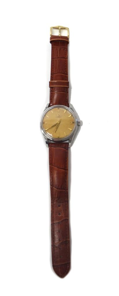 A gentleman's circular steel cased Omega wristwatch, the signed circular dial with gilt Arabic and arrow shaped numerals, tapering gilt hands and with