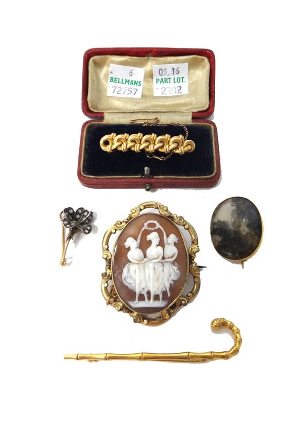 A Victorian 9ct gold brooch, designed as a walking stick, Birmingham 1894, an oval moss agate set brooch, a rose diamond set brooch, designed as a flo