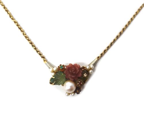 An Italian gold, faceted and carved gemstone and cultured pearl set necklace, the front in a floral and foliate design, mounted with a variety of gems