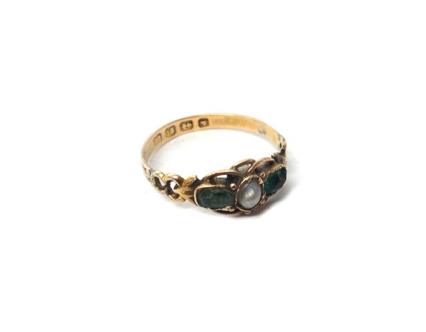 A Victorian 12ct gold ring, mounted with a half pearl at the centre, between two green gems, the mount with engraved and pierced decoration, Birmingha