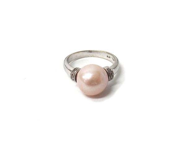 A white gold ring, mounted with a central cultured pearl between diamond set three stone curved shoulders, detailed 750, ring size O and a half.