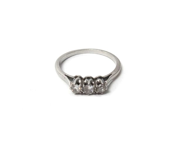 A diamond set three stone ring, claw set with a row of cushion shaped diamonds, ring size M and a half.