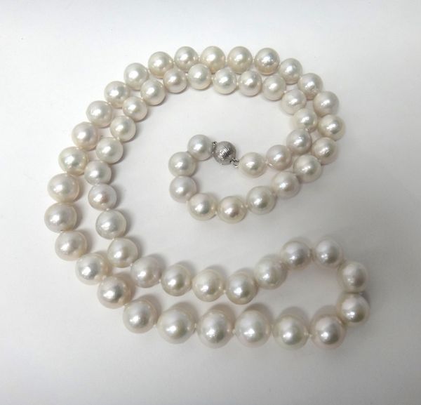 A single row necklace of large, slightly graduating cultured pearls, on an 18ct white gold and diamond set textured clasp, diameter of largest pearl 1