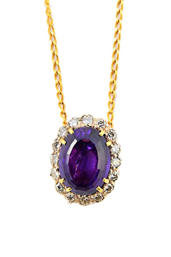 An amethyst and diamond set oval cluster pendant, claw set with the oval cut amethyst at the centre, within a surround of circular cut diamonds, on a