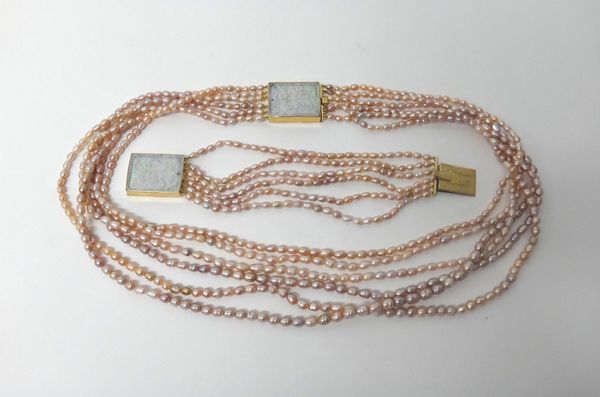 A six row necklace of pink tinted freshwater cultured pearls, on a 9ct gold mounted rectangular carved jade clasp, having a floral spray motif, togeth