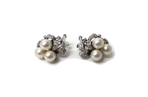 A pair of white gold, cultured pearl and diamond set earclips, each in a scrolling design, mounted with three cultured pearls and otherwise set with c