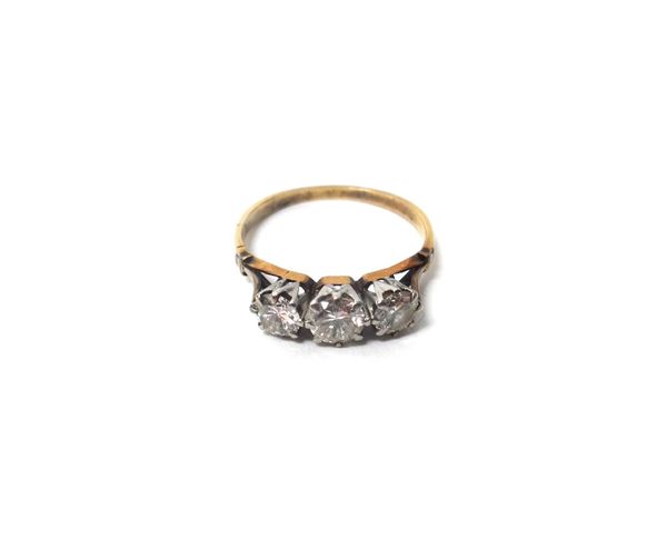 A diamond set three stone ring, claw set with a row of circular cut diamonds, between split 'V' shaped shoulders, ring size Q, with a case.