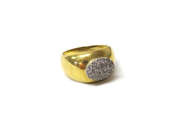 An Italian gold and diamond set oval cluster ring, mounted with small circular cut diamonds, detailed 18 K Italy, ring size L.