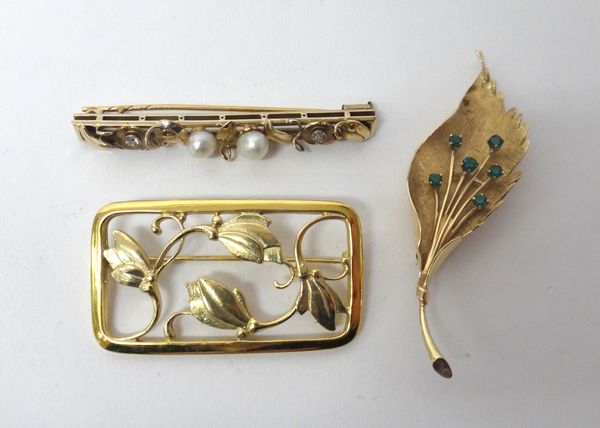 A gold, diamond and cultured pearl set brooch, decorated with foliate motifs and with flowerheads, mounted with two cushion shaped diamonds and with t