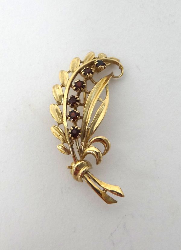 A 9ct gold and garnet set brooch, designed as a foliate spray, London 1975, gross weight 5.1 gms.