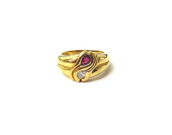 A gold, ruby and diamond set two stone ring, mounted with a pear shaped ruby and with a pear shaped diamond, in a twist over design, detailed 750, rin