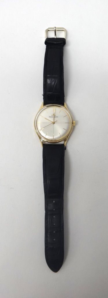 A gentleman's gold circular cased Jaeger Le Coultre wristwatch, the signed circular silvered dial with gilt baton shaped numerals and with centre seco