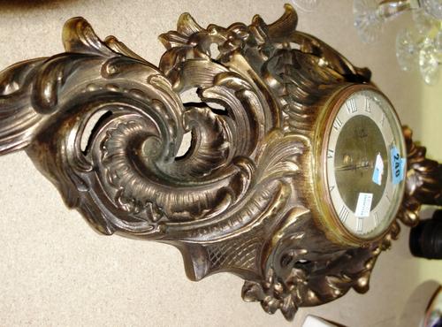 A pair of binoculars, another similar, and a gilt metal wall clock. (3)