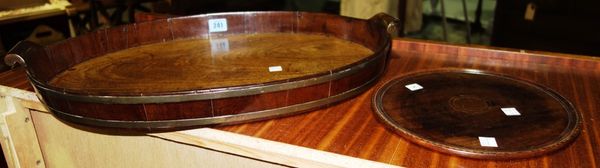 A oval mahogany twin handled tray with galleried edge together with a smaller circular tray. (2)