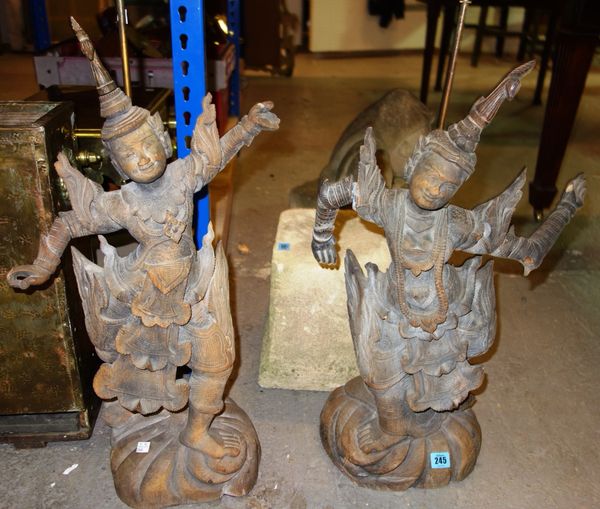 A pair of 20th century hardwood carved Eastern figures converted into lamps. (2)