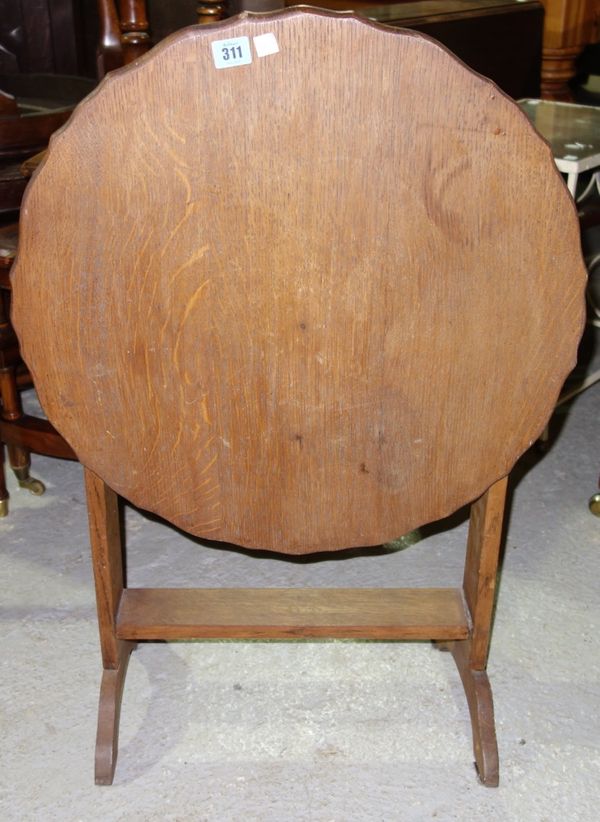 A 1930's oak round tilt top coffee table.