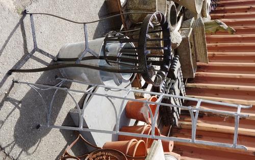 A metal six tier plant pot stand, a black painted jardiniere stand and three metal buckets.