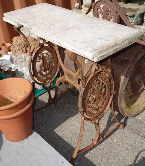 A cast iron marble top table base.