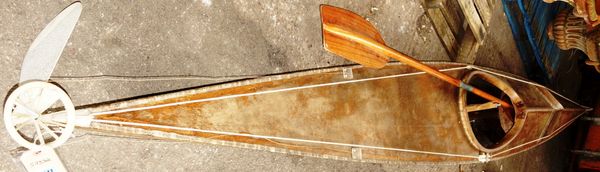 A 20th century wooden kayak and a GEES paddle.