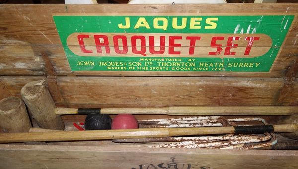 A part Jacques croquet set contained in a pine box.