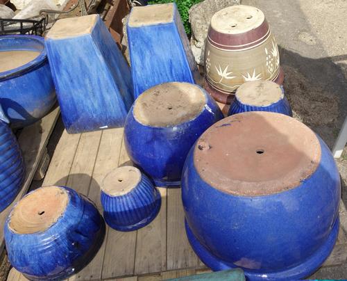 A group of seven assorted blue glazed planters , a brown and green glazed planter and a terracotta plant pot. (9)