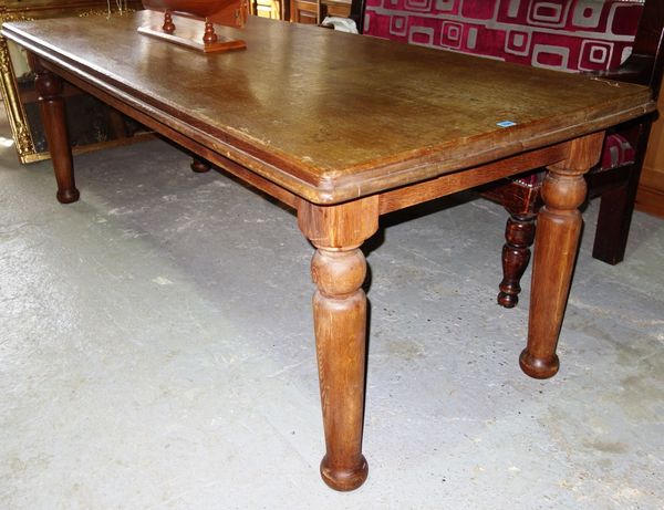 An early 20th century oak plank top kitchen table