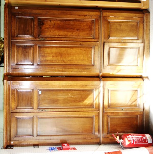 A pair of large 20th century oak corner cabinets, with panelled doors. (2)