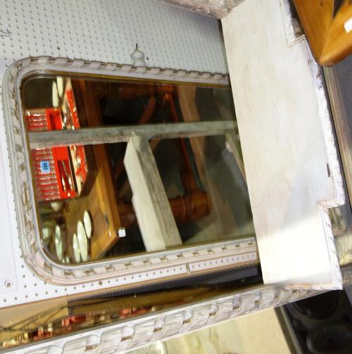 A 19th century later cream painted cheval mirror with open spiral turned frame and stand on lions paw feet, 84cm wide.