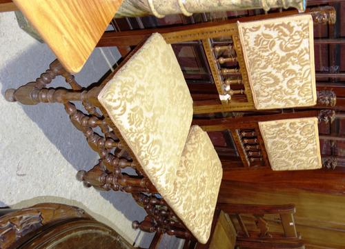 A near pair of 19th century Italian fruitwood side chairs with carved grotesque finials and turned supports.