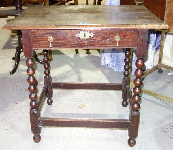 A 19th century oak rectangular side table, with bobbin turned legs and perimeter stretcher.