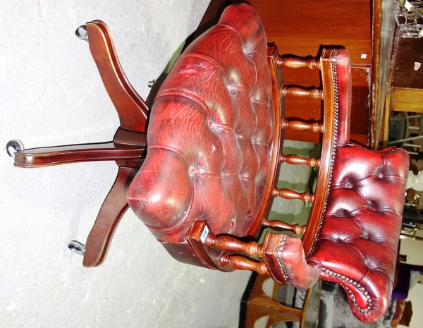 A 20th century red leather swivel desk chair.