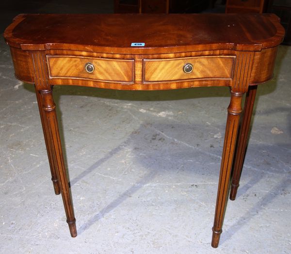 A 20th century mahogany serpentine side table.
