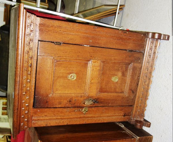 A small oak cupboard with panelled door.