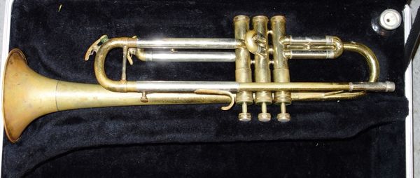 A 20th century trumpet, cased, together with a modern bagatelle board, a zinc watering can and a pair of ski boots. (4)