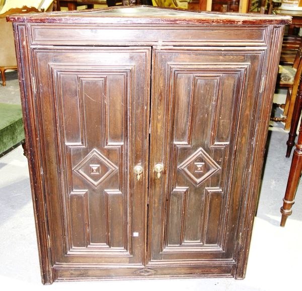 A 20th century stained pine corner cupboard.