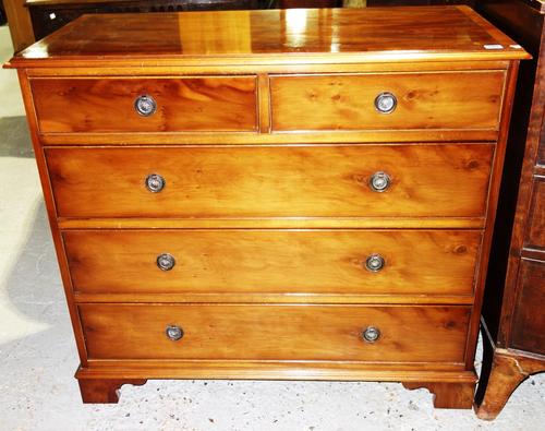 A 20th century yew wood chest of two short and three long drawers.