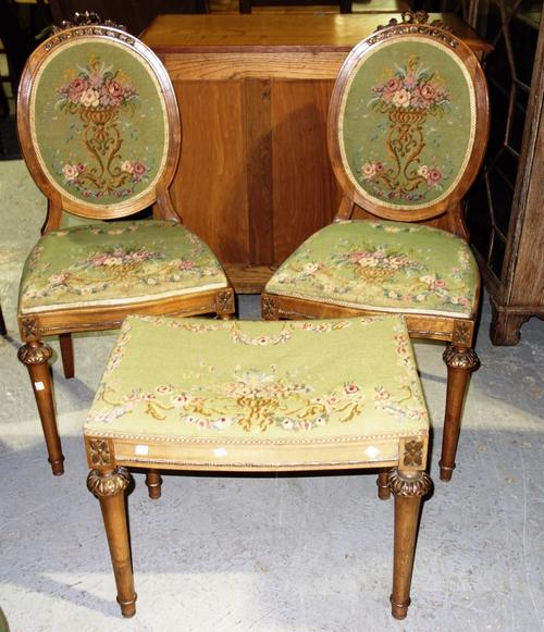 A pair of 20th century parcel gilt side chairs and a stool. (3)