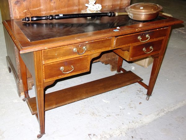 An Edwardian mahogany four drawer writing desk.