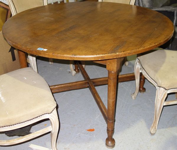 A late 19th century circular oak kitchen table.