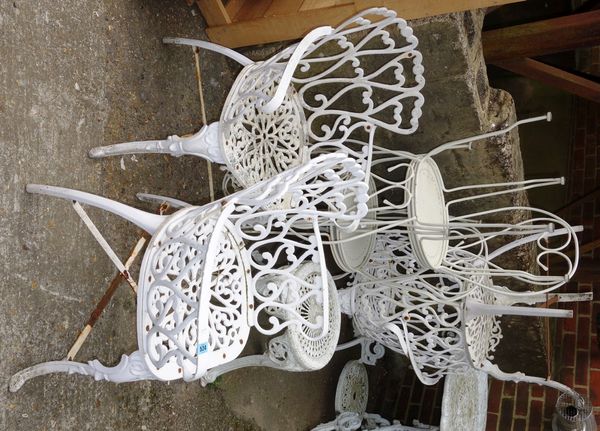 A group of seven assorted white painted metal garden chairs.