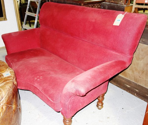 A red upholstered two seat sofa.