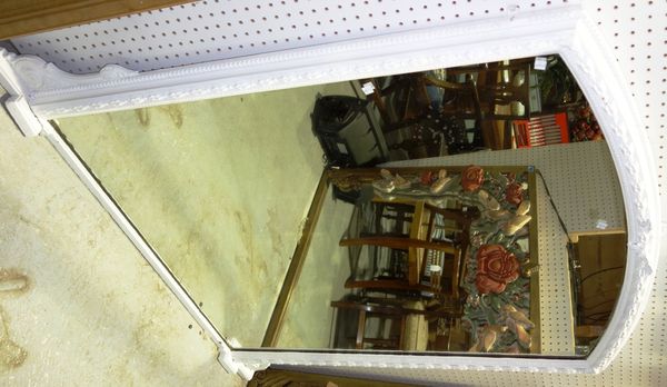 A large white painted overmantel mirror.