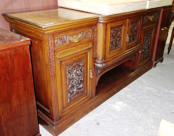 A 20th century profusely carved mahogany sideboard.