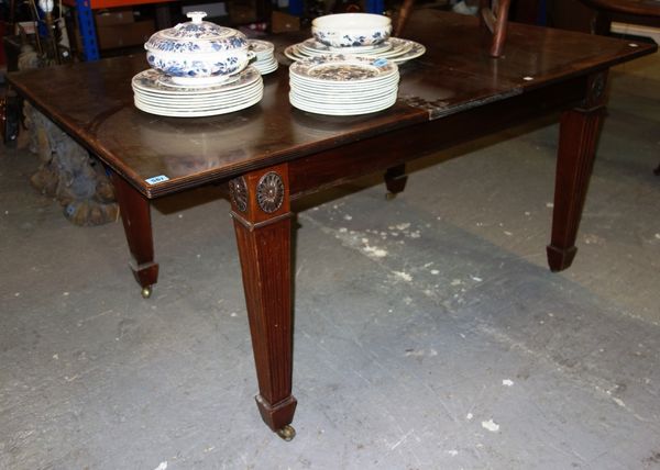 A rectangular mahogany dining table with one additional leaf.